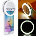 Smartphone with a ring light attachment on a white background