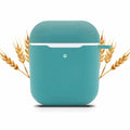 Teal square-shaped case with a white interior, surrounded by wheat stalks on a white background