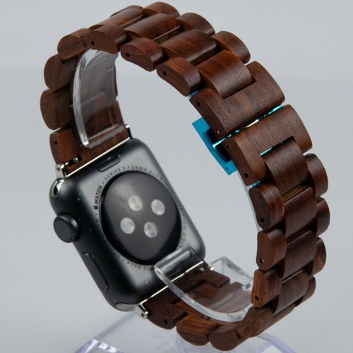 Smartwatch with a wooden band on a clear stand against a gray background